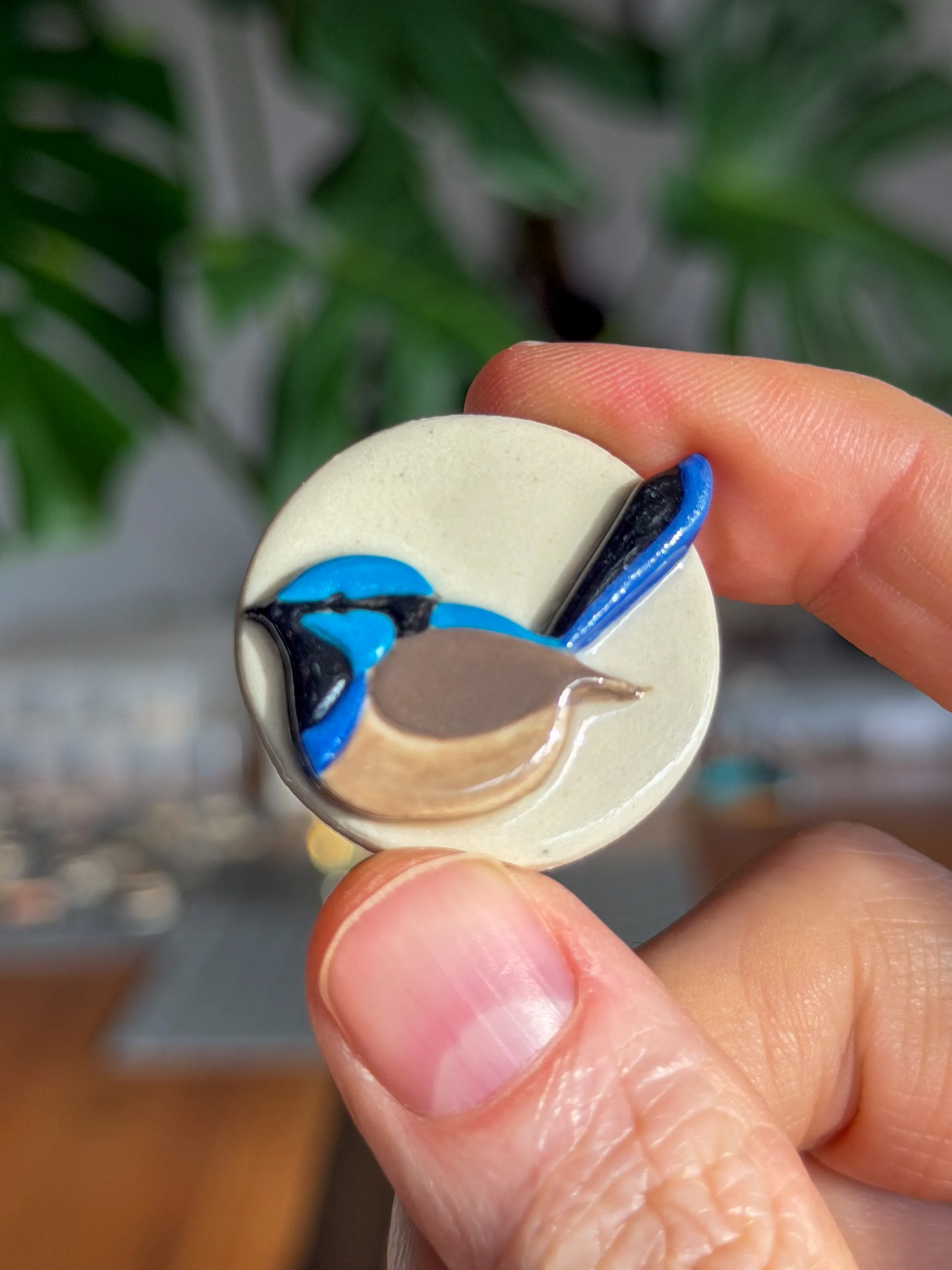Hand-sculpted ceramic brooch of a blue superb fairywren